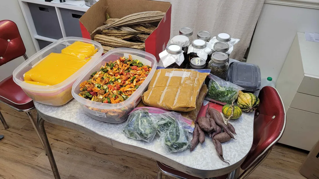 Preserved and processed garden produce including dried peppers, sweet potatoes, and canned goods