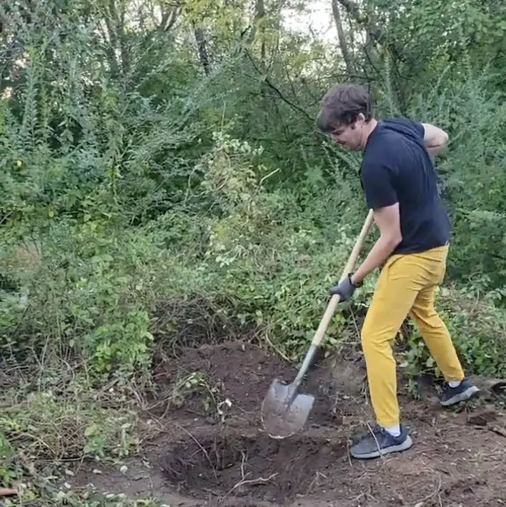 Volunteer shoveling at Flat Rock